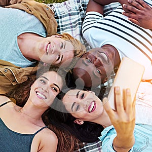 Our together is kinda like forever. a group of young friends taking a selfie together outdoors.