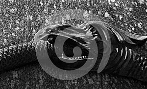 Ouroboros snake eating its own tail. a snake swallowing its tail. symbol of eternity and rebirth. fragment of the monument of Gl photo