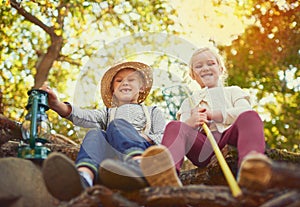 Out for an adventure together. Portrait of two little children playing together outdoors.