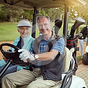 Out for a day on the green. Portrait of a smiling senior couple riding in a cart on a golf course.