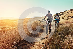 Out on an epic mountain biking adventure. two cyclists out cycling in the countryside.