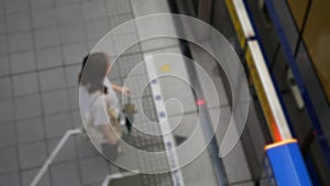 out of focus blur top down view to passengers traveller waiting on subway platform station ready to boarding the train commuter in