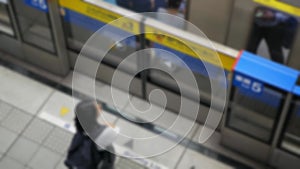 out of focus blur top down view to passengers traveller waiting on subway platform station ready to boarding the train commuter in