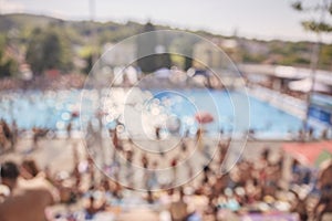 Out of focus, defocused shot, group of unrecognizable people outdoors, large crowd, swimming pool,