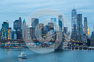 Out of focus image of Brooklyn Bridge and Lower Manhattan skyline at night, New York city, USA.