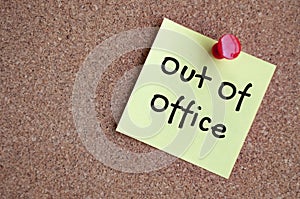Out of office text on sticky note. Out of office concept
