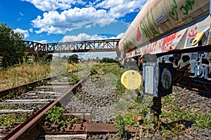 Out of order - old railway signal beside the track next to waggons full of grafitti