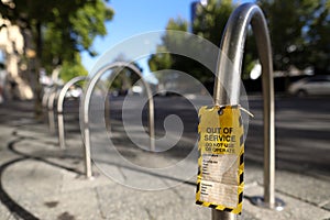 Out of service tag attached on faulty defect hand ascender do not operation on bike rack public park photo