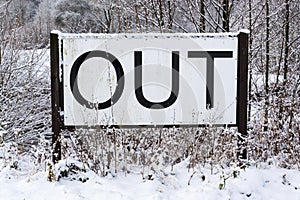 Out sign in snowy landscape, New Years Resolutions, self-improvement concept, lifestyle change, mind-body improvement