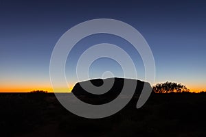 Outback, Australia - November 12, 2022: Sunrise at the Majestic Uluru or Ayers Rock in the Northern Territory, Australia. The red