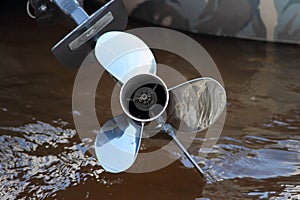 Outboard motor boat propeller on water