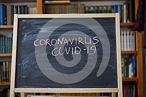 Outbreak Warning. written white chalk on blackboard in connection with epidemic of coronavirus worldwide