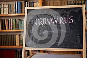 Outbreak Warning. written white chalk on blackboard in connection with epidemic of coronavirus worldwide