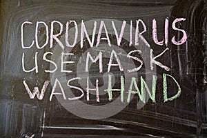 Outbreak Warning. written white chalk on blackboard in connection with epidemic of coronavirus worldwide