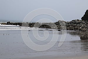 An outcropping of rock with a beach