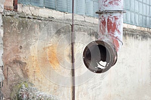 Old ventilation system, rusty duct on the facade of the building.