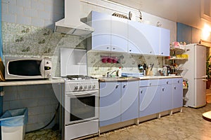 Outdated kitchen interior with a hundred finishes and a simple kitchen set