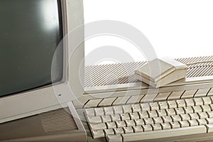 Outdated technology. Dirty vintage computer system with keyboard photo