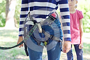 Children prepare for a bungee jump, put on safety belts