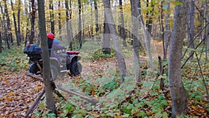 Outdoor activity - family riding ATVs in the woods - autumn season