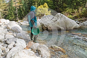 Outdoor adventures on river. Gold panning, search for gold