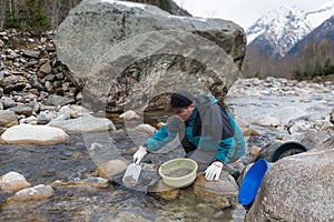 Outdoor adventures on river. Gold panning, search for gold in winter