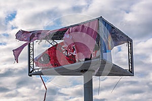 Outdoor advertising banner torn by the wind