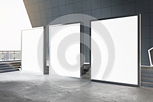 Outdoor advertising concept with perspective view on three blank white illuminated billboards with place for your logo or text on