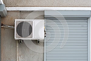 Outdoor air conditioning unit on the house facade