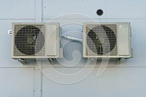 Outdoor air conditioning unit. A large modern air conditioner on the wall of an apartment building. Repair and maintenance of the