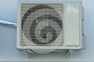 Outdoor air conditioning unit. A large modern air conditioner on the wall of an apartment building. Repair and maintenance of the