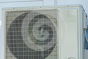 Outdoor air conditioning unit. A large modern air conditioner on the wall of an apartment building. Repair and maintenance of the