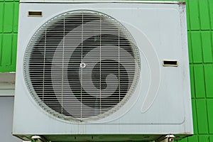 Outdoor air conditioning unit. A large modern air conditioner on the wall of an apartment building. Repair and maintenance of the