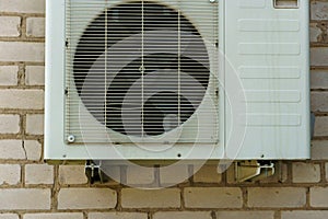 Outdoor air conditioning unit. A large modern air conditioner on the wall of an apartment building. Repair and maintenance of the