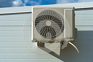 Outdoor air conditioning unit. A large modern air conditioner on the wall of an apartment building. Repair and maintenance of the