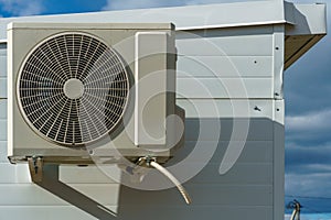 Outdoor air conditioning unit. A large modern air conditioner on the wall of an apartment building. Repair and maintenance of the