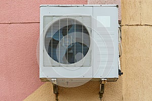 Outdoor air conditioning unit. A large modern air conditioner on the wall of an apartment building. Repair and maintenance of the