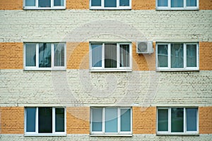 Outdoor air conditioning unit. A large modern air conditioner on the wall of an apartment building. Repair and maintenance of the