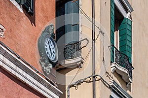 Outdoor analog wall street clock in Venice, Italy