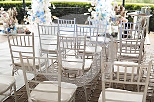Outdoor area for wedding ceremonies with white chairs.