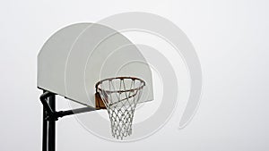 Outdoor basketball hoop against a clear sky on a calm day