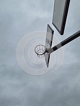 Outdoor basketball rings with chain nets at different levels. Street basketball hoop with a view from below. Street sport during