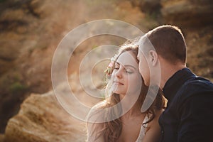 Outdoor beach wedding ceremony, close up of stylish happy romantic couple together