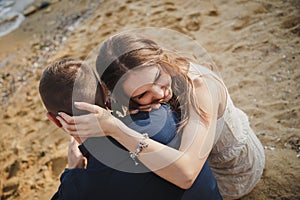 Outdoor beach wedding ceremony, close up of stylish happy romantic couple together