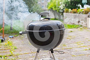 Outdoor black barbecue grill on a terrace photo