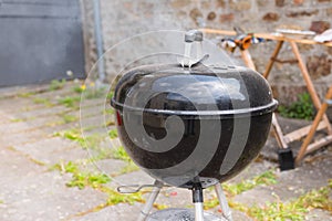 Outdoor black barbecue grill on a terrace photo