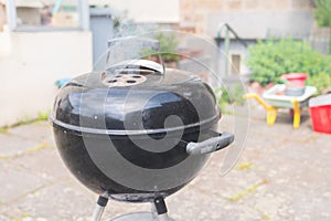 Outdoor black barbecue grill on a terrace photo