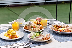 Outdoor breakfast setting with eggs Benedict
