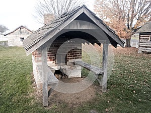 Outdoor brick oven with wooden shingled shelter