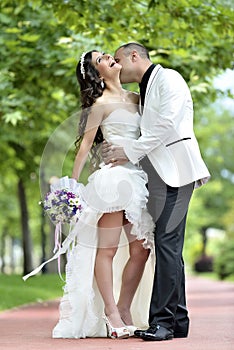 Outdoor Bride and groom kiss